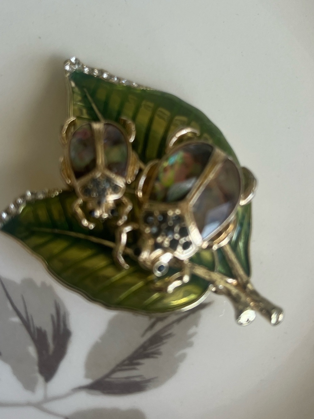 Vintage Napier, two beetle brooch sitting on a leaf with abalone style shells